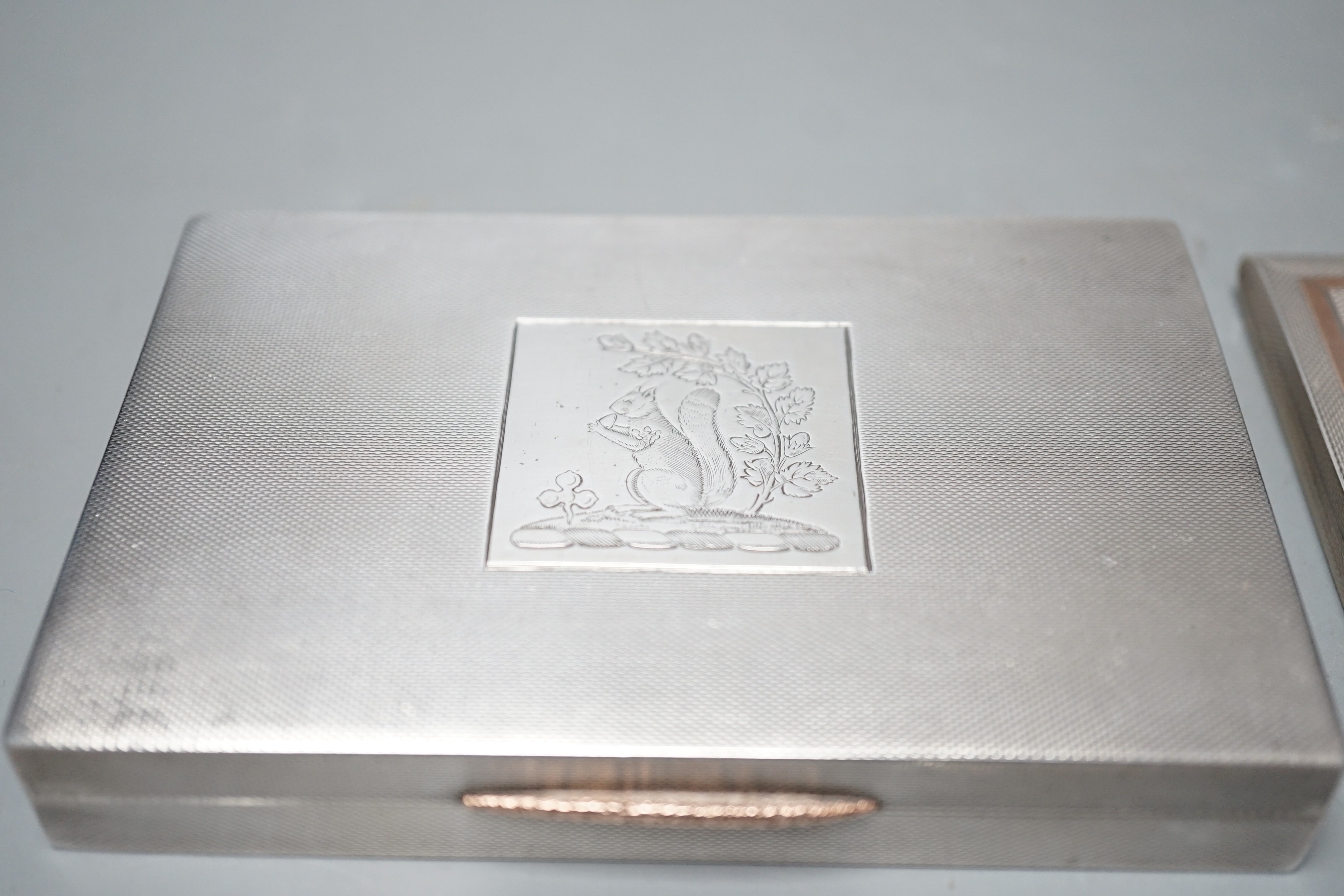 A George VI engine turned silver rectangular cigarette box/case, engraved with a squirrel, W.H. Manton Ltd, Birmingham, 1942, 12.2cm, one other Mappin & Webb silver cigarette case and a continental white metal snuff box.